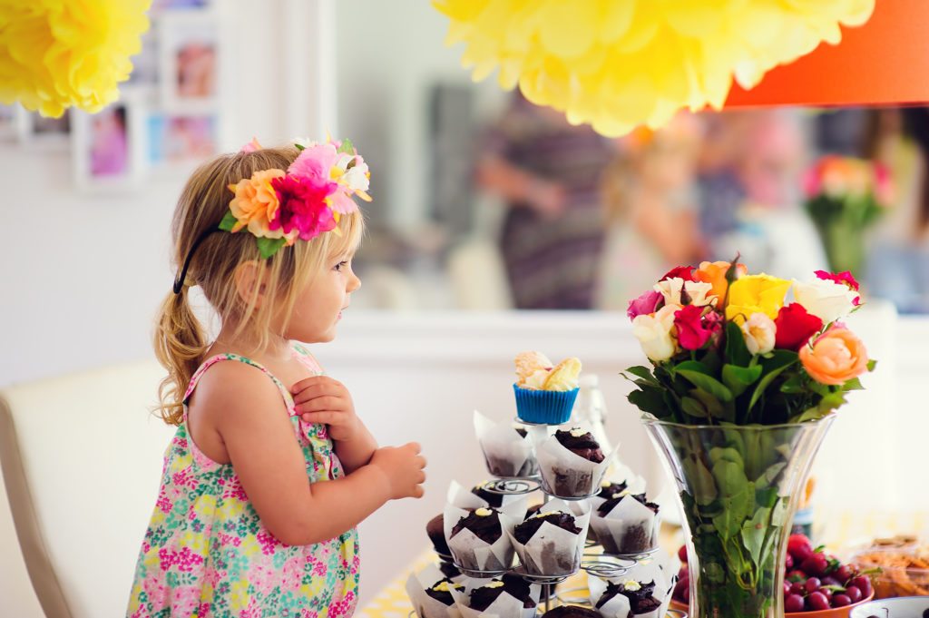 little-girl-with-flowers-in-her-hair-and-bouquet-in-vase